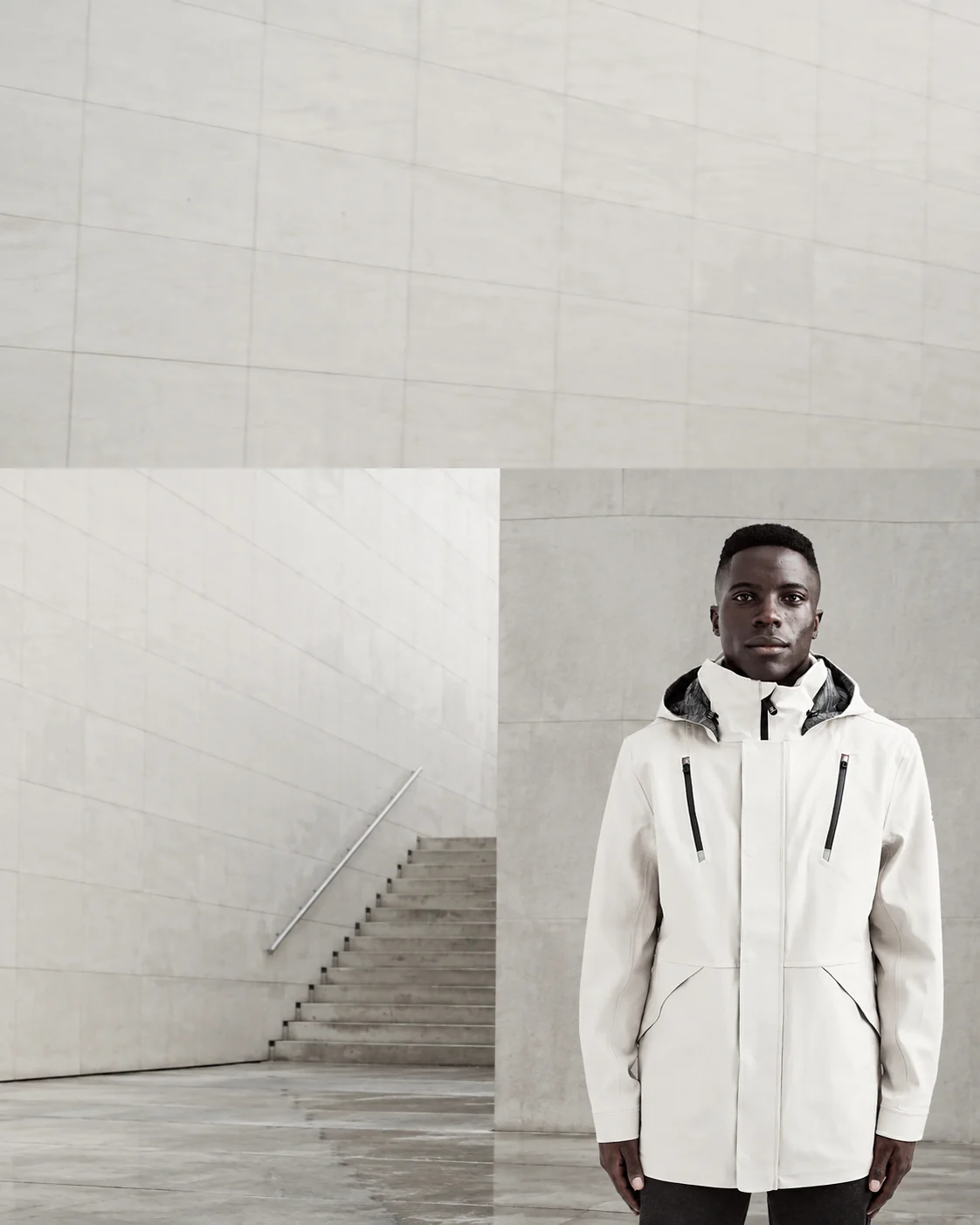 Front-facing model wearing the Ulterior Waterproof Hardshell Jacket in off-white